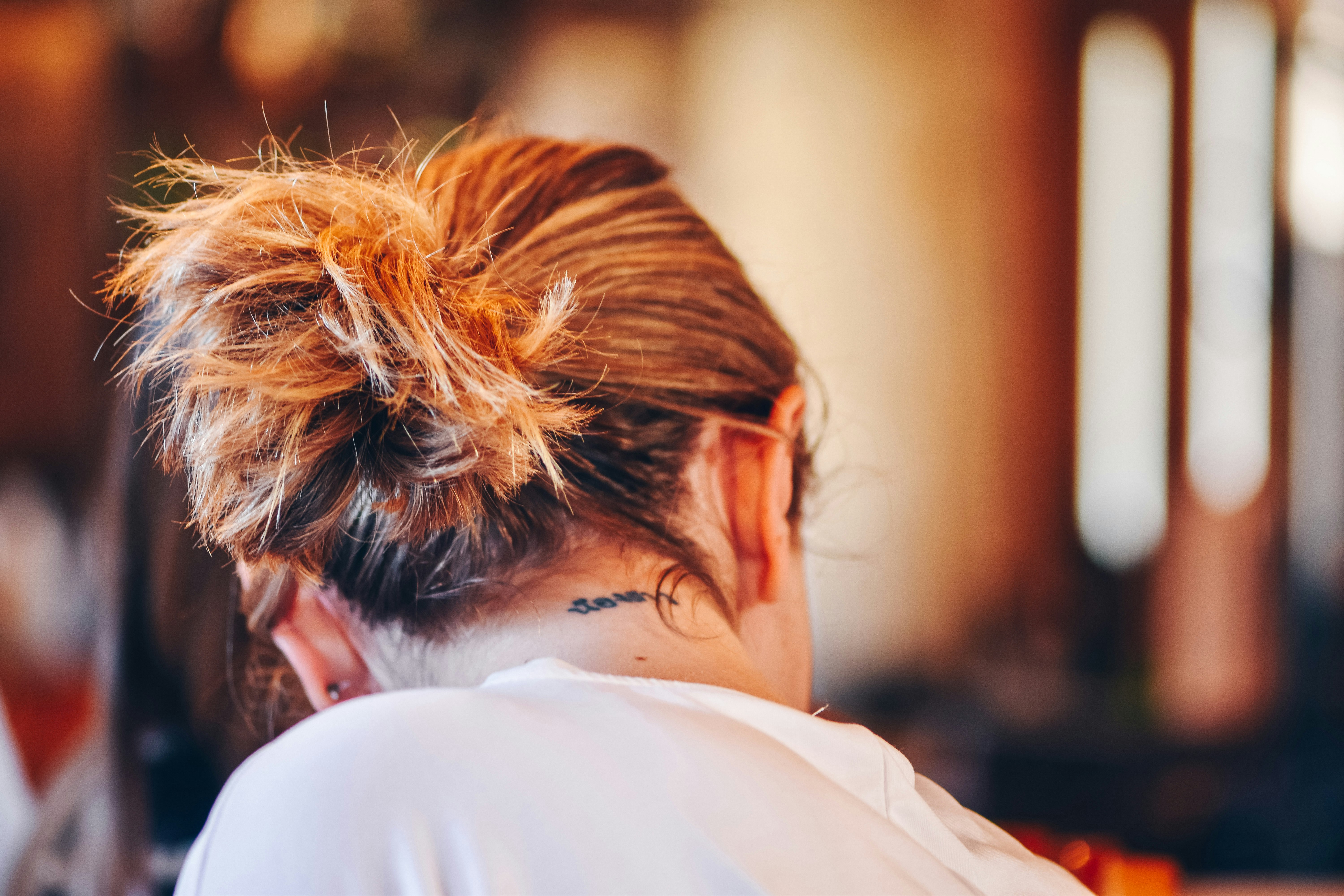 selective focus photography of woman in white top